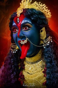 a woman with blue face paint and red lips