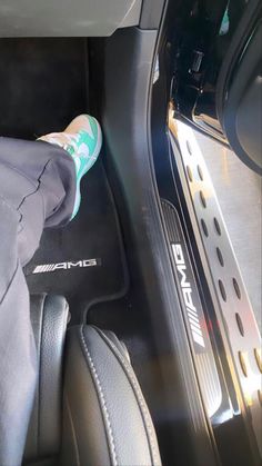 someone's feet in the center console of a car