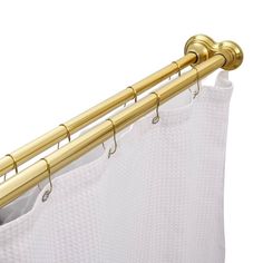 the curtain rod is attached to the side of a white shower curtain with gold hardware