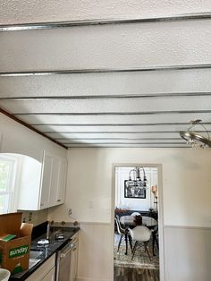 an open door leading to a kitchen and dining room