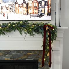 a fireplace decorated for christmas with garland and lights