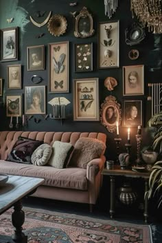 a living room filled with lots of framed pictures on the wall next to a couch