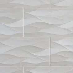 a white tile wall with wavy waves on it