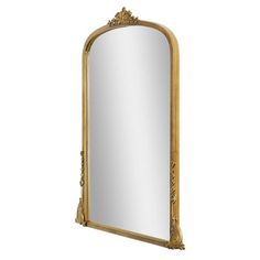 an ornate gold framed mirror against a white background