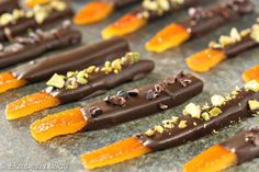 chocolate and orange candy sticks with nuts on them