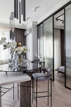 an elegant dining room with glass table and chairs