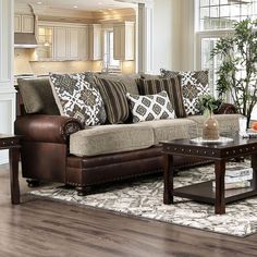 a living room filled with furniture and a coffee table in front of a large window