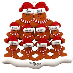 a christmas ornament with the names of five children in santa hats and mittens