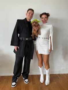 the man and woman are dressed up as star wars characters, one holding a teddy bear