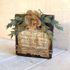 an old book is decorated with leaves and burlucks on the front cover