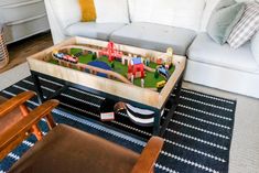 a child's toy train table in the living room