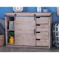 a wooden cabinet with two drawers and some baskets on the floor in front of it