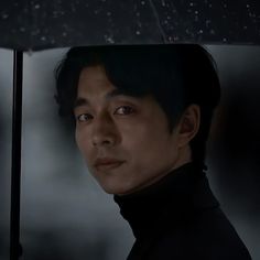 a man holding an umbrella in the rain