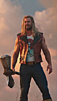 a man with long hair holding an ax in his right hand and wearing a leather vest