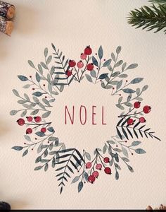 a christmas wreath with the word noel painted on it