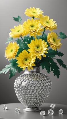 a vase filled with lots of yellow flowers on top of a table next to diamonds