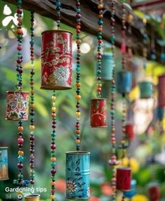 colorful tin can wind chimes hanging from a tree