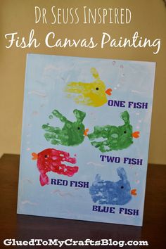 a handprinted card with two fish and one fish on it sitting on a table