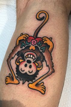 a monkey tattoo on the leg of a man