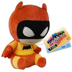 a small stuffed animal with a bat on it's chest next to a card