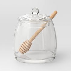 a glass jar with a wooden toothbrush inside