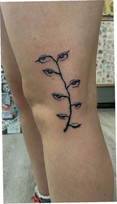 a woman's leg with a small tattoo design on the lower part of her thigh