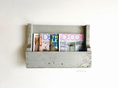 an old wooden shelf with magazines on it's sides and the words decor above them