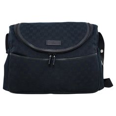 This Gucci diaper bag is the perfect mix of functional and chic. Black coated canvas with all over monochromatic Gucci logos and black leather trim. Exterior pockets on the front, back and sides for easy access to things that you need quickly. Rounded zipper with 2 pulls. Large interior compartment fits everything that you need with smaller interior pockets to help keep you organized. Interior is nylon lined for easy clean up. Chevron twill adjustable cross body strap with silver metal accents. Luxury Gucci Monogram Canvas Satchel, Gucci Diaper Bag, Gucci Coat, Gucci Black, Messenger Bags, Metallic Accents, Easy Clean, Early 2000s, Black Coat