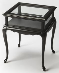 a small black table with a glass top and two drawers on each side, sitting against a white background