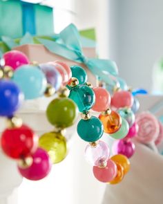 colorful bracelets hanging from the side of a white chair