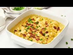 a casserole dish with peas and bacon in it on a white counter top