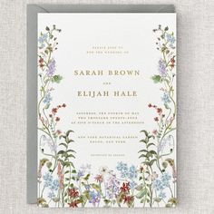 a wedding card with flowers and leaves on it