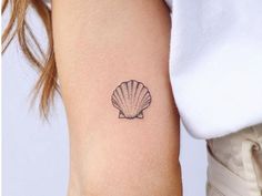 a small shell tattoo on the right arm