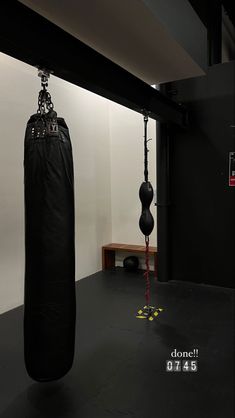 a black punching bag hanging from the ceiling