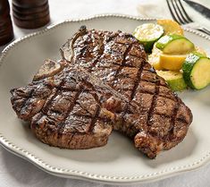 a steak and vegetables on a white plate