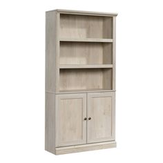 a white bookcase with two doors and drawers on the bottom, in front of a white background