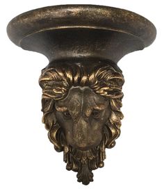 a lion's head is mounted on the side of a light fixture with an ornate design