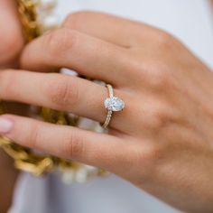 a close up of a person's hand holding a ring