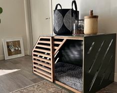 a dog house made out of an old crate and some other things on the floor