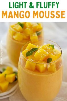 two glasses filled with mango mousse and garnished with mint