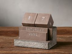 two cardboard blocks stacked on top of each other with the words saturday june written on them