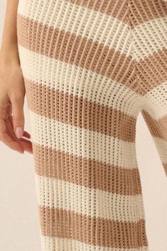 a close up of a woman's legs in striped knits and leggings