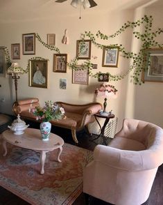 a living room filled with furniture and pictures on the wall