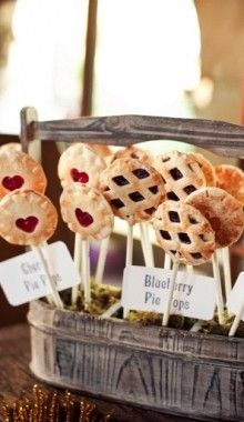 some pies are on sticks with blueberry toppings