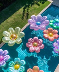 an aerial view of flowers floating in a pool