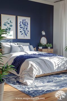 a bedroom with blue walls and white bedding in the center is decorated with potted plants