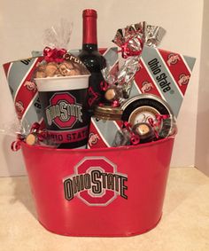 a red bucket filled with wine and snacks