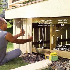 a man is working on the side of a house with wood framing and sidings