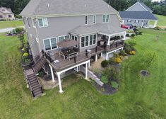 an aerial view of a house with deck and patio