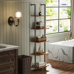 a bathroom with a tub, sink and shelves in it's corner next to a window